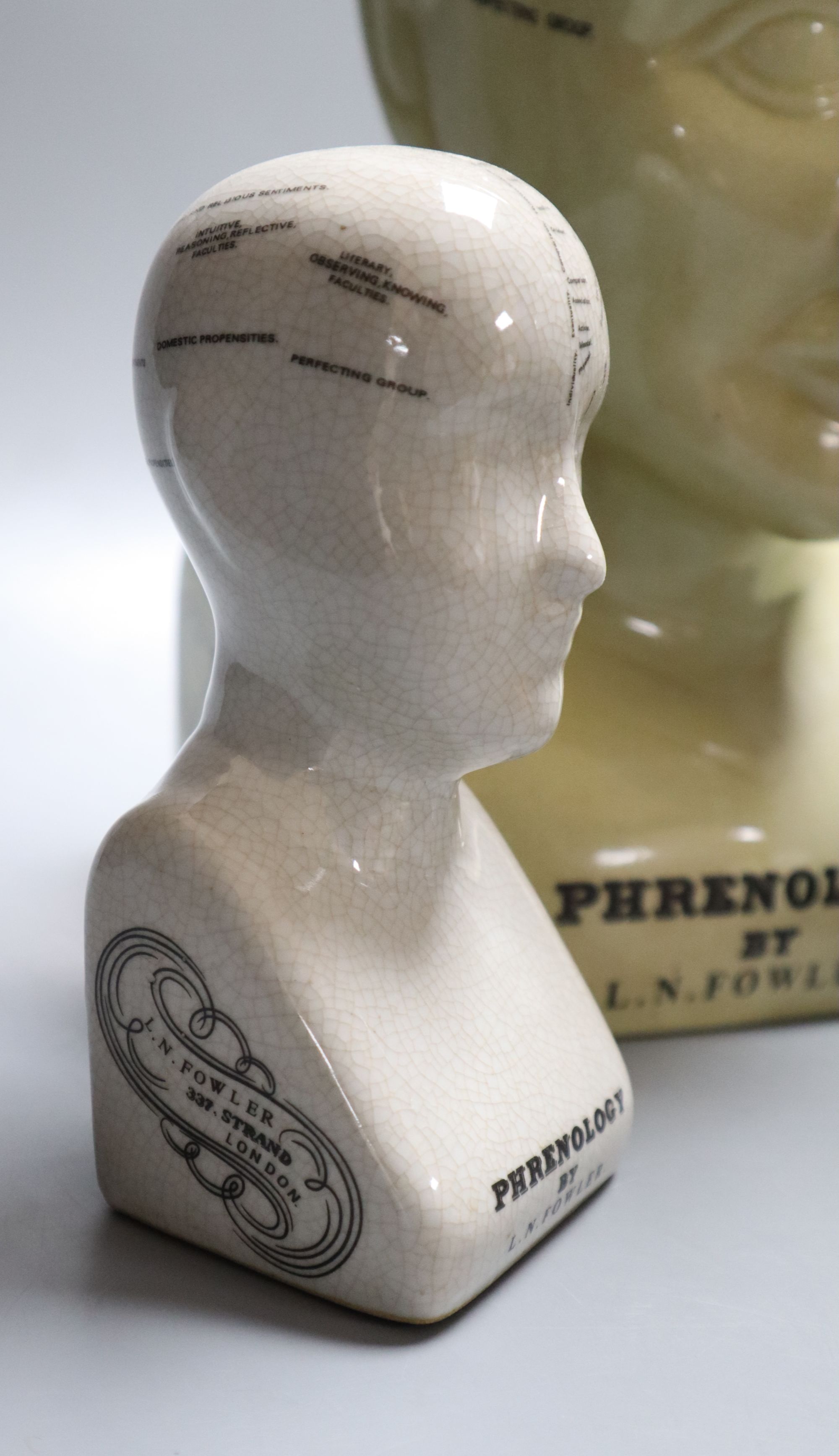 Three reproduction phrenology ceramic heads, by L.M. Fowler, tallest 29cm